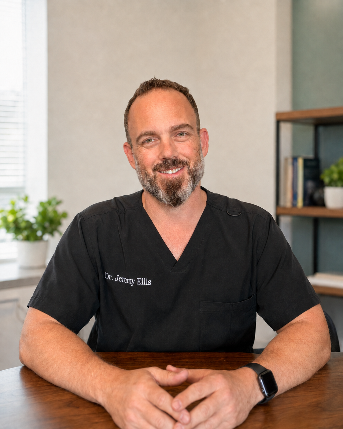 Dr. Jeremy Ellis seated in a modern consultation setting